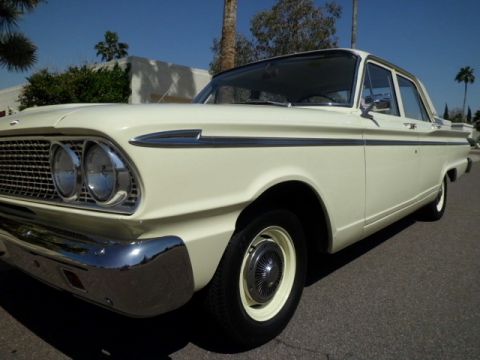1963 Ford Fairlane - Cream-colored 1963 Ford Fairlane sedan parked on asphalt under a clear blue sky.
