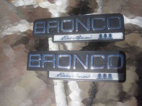 1993 Ford Bronco - Two Ford Bronco Eddie Bauer emblems are shown, each with "BRONCO" and "Eddie Bauer" text.
