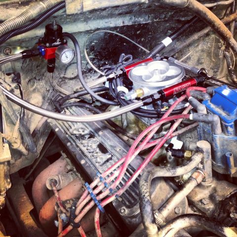 1995 Ford Bronco - Close-up view of an engine bay showing aftermarket fuel system components and wiring.