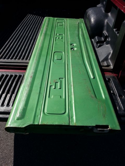 1967 Ford F-100 - A green Ford tailgate is shown, with the brand name embossed on its surface.