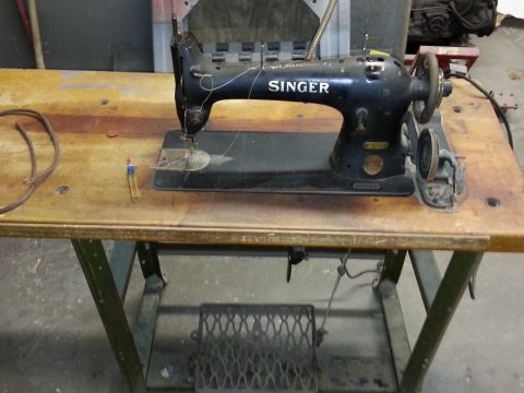 1967 Ford F-100 - Vintage Singer sewing machine with visible branding, placed on a workbench.