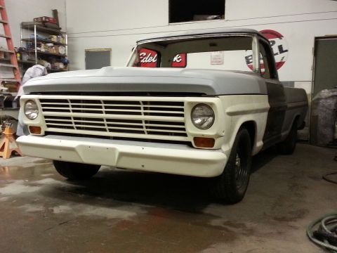 1967 Ford F-100 - This 1967 Ford F-100 truck is undergoing restoration, showing its front end with a primer gray hood and roof.