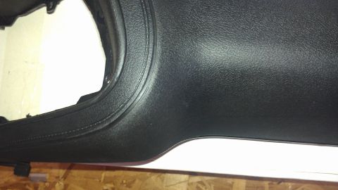 1973 Chevrolet Camaro - Close-up of a textured black plastic dashboard trim piece, likely from an older vehicle.