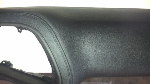 1973 Chevrolet Camaro - The textured surface of a vehicle's dashboard is shown, with a curved seam detail.