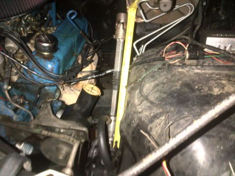 1980 Ford F-150 - Measuring steering column components in an engine bay with various parts and wiring.