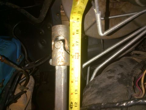 1980 Ford F-150 - A close-up view of a steering shaft universal joint with a tape measure indicating its size.