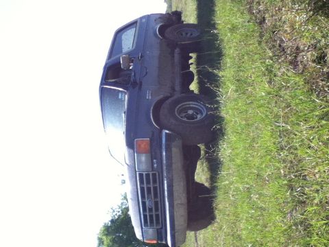 1988 Ford Bronco - This 1988 Ford Bronco is captured in a 3q-front view while parked on a grassy incline.