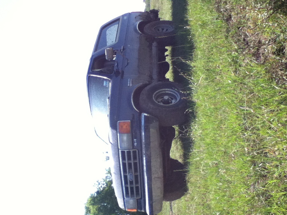 Dark blue 1988 Ford Bronco 3q-front view on grassy incline