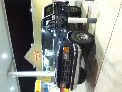 1988 Ford Bronco - This 1988 Ford Bronco is parked at a gas station with a "Seafood Market" sign in the background.