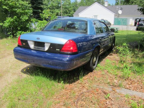 2001 Ford Crown Victoria - Rear view of a blue Ford Crown Victoria with a light blue section on the trunk and roof.