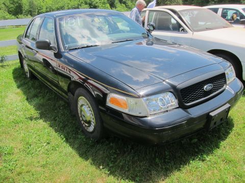 2001 Ford Crown Victoria - Black 2001 Ford Crown Victoria, possibly a former police or fire vehicle, parked outdoors.