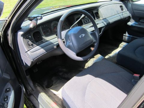 2001 Ford Crown Victoria - Interior view of a 2001 Ford Crown Victoria, highlighting the dashboard and seating.