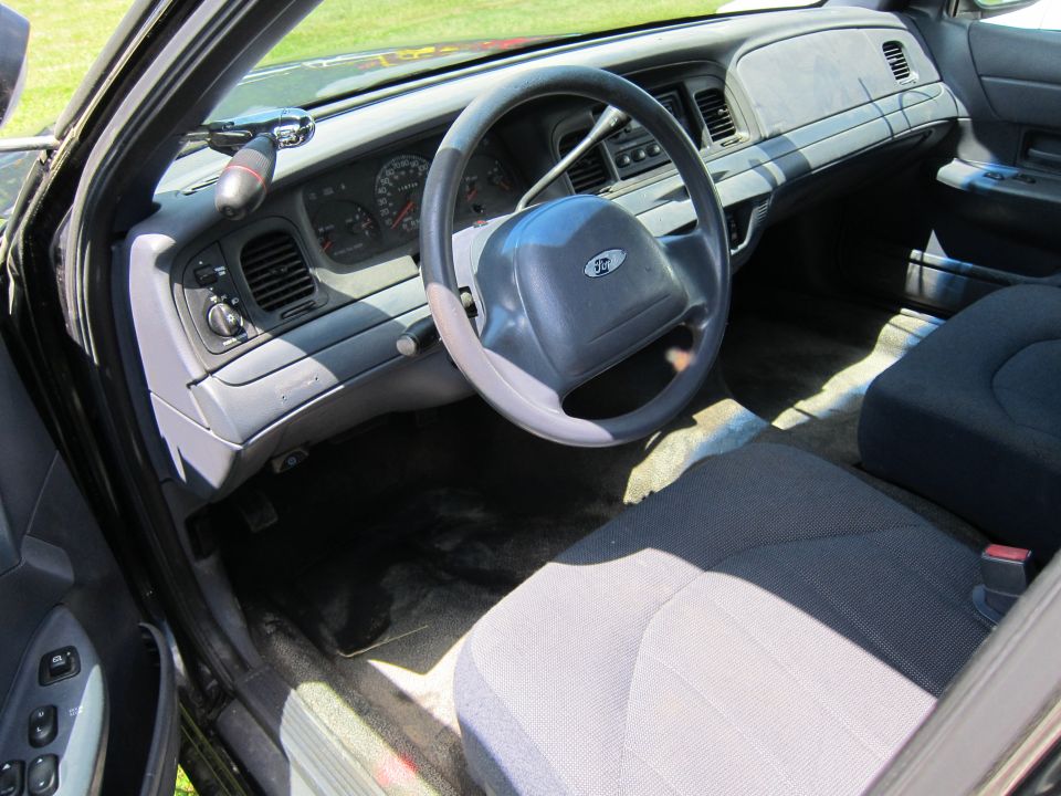 2001 Ford Crown Victoria interior showing dashboard, steering wheel, and front seats