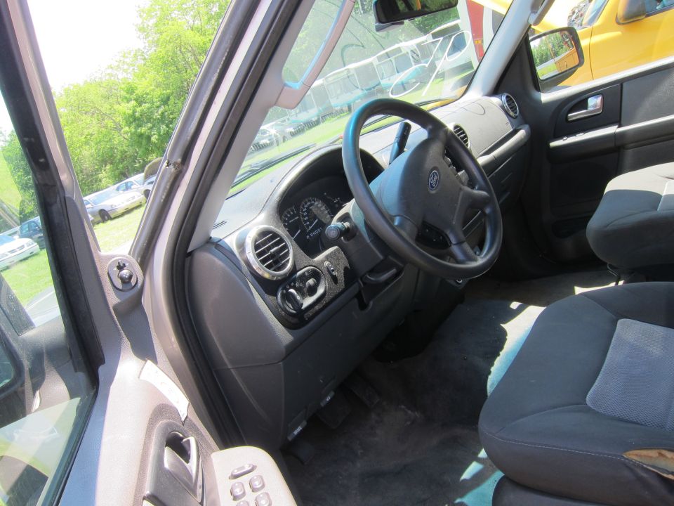 Interior view of a car showing dashboard, steering wheel, and seats