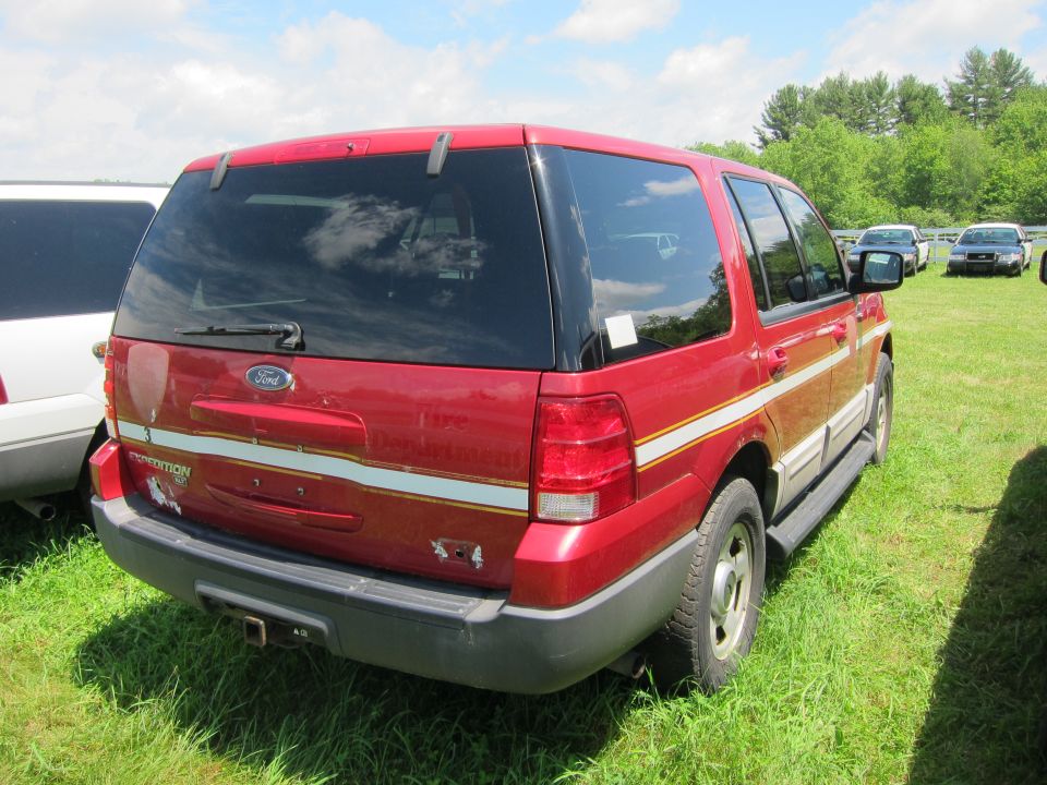 Red Ford Expedition rear view, showing "Expedition" badge and "Fire Department" text on the side