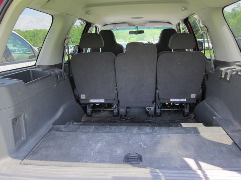 2001 Ford Crown Victoria - The interior of an SUV shows the rear seating folded down and the cargo area.