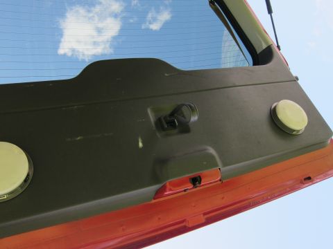 2001 Ford Crown Victoria - Interior view of a vehicle's rear hatch, showing the latch mechanism and circular covers.