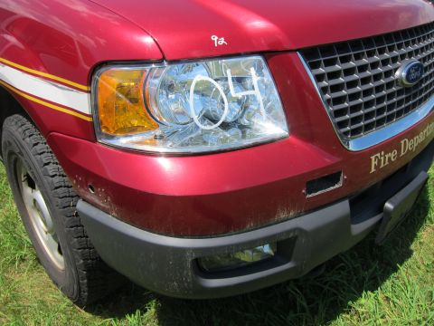 2001 Ford Crown Victoria - Front view of a red Ford SUV with 'Fire Department' text visible on the grille area.