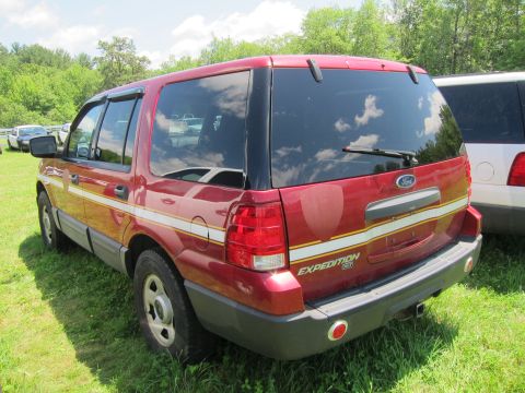 2001 Ford Crown Victoria - Rear view of a red Ford Expedition SUV with a white stripe detail on the side and tailgate.