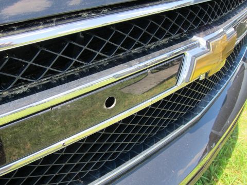 2001 Ford Crown Victoria - Front grille detail of a Chevrolet vehicle, showing the iconic bowtie emblem and surrounding chrome accents.