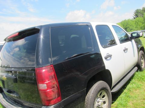2001 Ford Crown Victoria - A two-tone Chevrolet Tahoe SUV is viewed from the rear quarter, with other vehicles visible in the background.