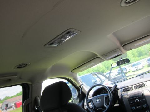2001 Ford Crown Victoria - Interior view of a vehicle with a Chevrolet steering wheel and other cars parked outside.