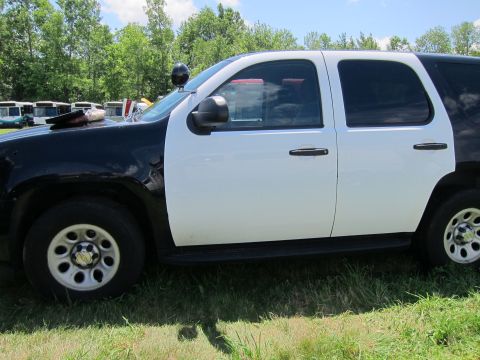 2001 Ford Crown Victoria - This police SUV is seen from the side, a two-tone black and white paint scheme and a light bar.