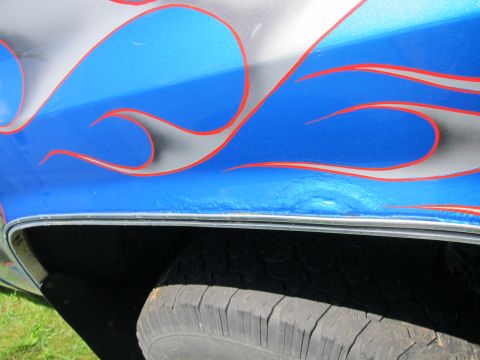 2001 Ford Crown Victoria - Side view of a car's fender custom flame paint with blue, silver, and red accents.
