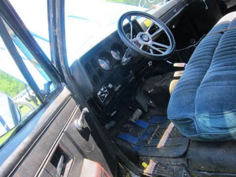 2001 Ford Crown Victoria - The interior of an older vehicle features a custom steering wheel and blue corduroy seats.