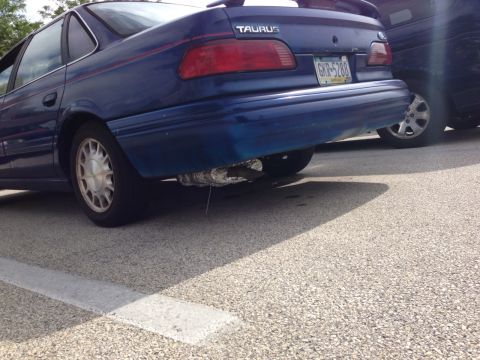 1996 Ford F-150 - Rear view of a blue 1996 Ford Taurus sedan parked next to another vehicle.