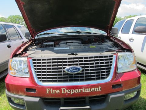 2001 Ford Crown Victoria - Front view of a red Ford Expedition, showing the grille and engine bay, with "Fire Department" text.