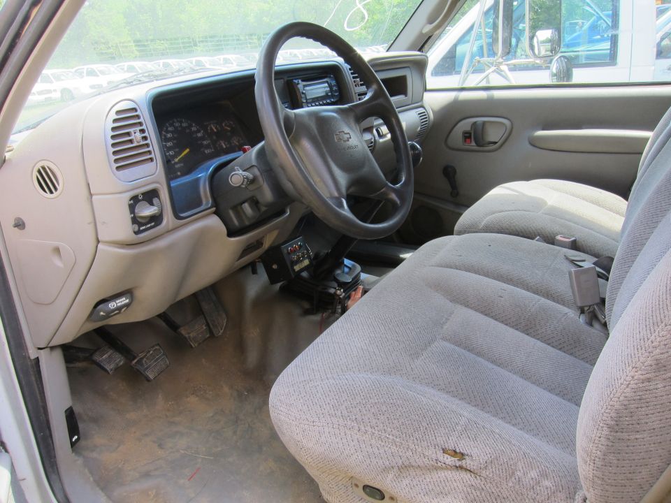 Interior of a 1995 Chevrolet pickup truck showing dashboard, steering wheel, and seats