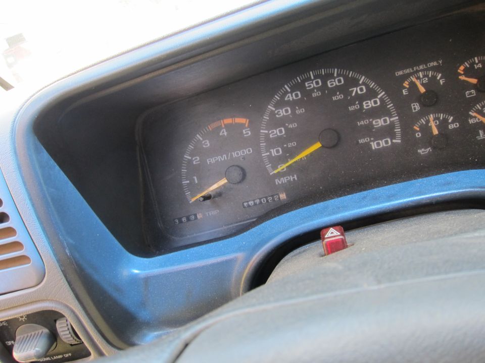 Dashboard with speedometer, tachometer, and fuel gauge. Odometer reads 70702