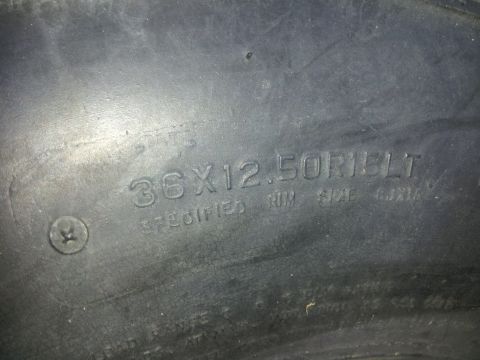 1986 Ford Bronco - Close-up of tire sidewall text indicating size and rim specifications.