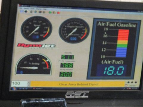 2003 Ford Crown Victoria - monitor displays DynoJet tuning software with speed and engine-speed gauges and an air/fuel gasoline scale reading 18.0.