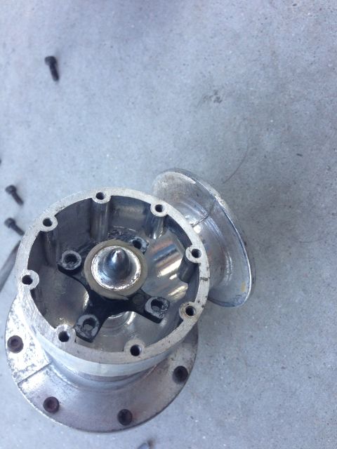 1996 Ford Probe - An aluminum automotive part, possibly a hub or cover, is shown disassembled with screws scattered around it.