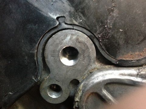 1996 Ford Probe - Close-up of an engine component, likely a timing belt cover seal, showing metal parts and a rubber seal.