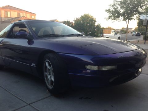 1996 Ford Probe - A purple 1996 Ford Probe is parked in a driveway.