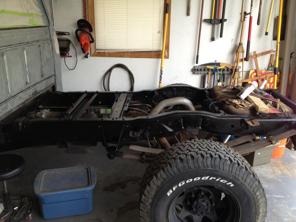 1979 Ford F-350 frame and tire in garage. BFGoodrich tire is visible