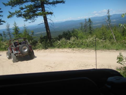 2005 Jeep Wrangler - A 2005 Jeep Wrangler is parked on a dirt road with a scenic mountain vista in the background.