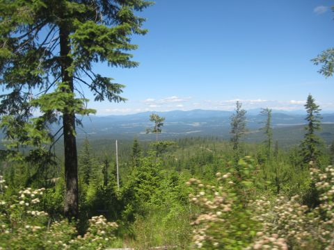 2005 Jeep Wrangler - A vast mountain landscape unfolds under a clear blue sky, with a Supermotors.net logo in the corner.