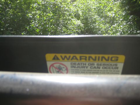 2005 Jeep Wrangler - A yellow warning sticker inside a vehicle reads 'WARNING DEATH OR SERIOUS INJURY CAN OCCUR'.