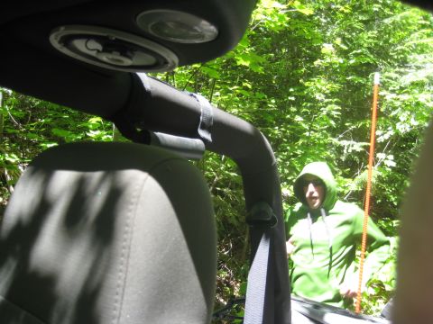 2005 Jeep Wrangler - Interior view of a 2005 Jeep Wrangler with a person standing in the woods behind it.
