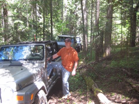 2005 Jeep Wrangler - Two Jeep Wranglers navigate a forest trail. The front Jeep is a tan Rubicon model.