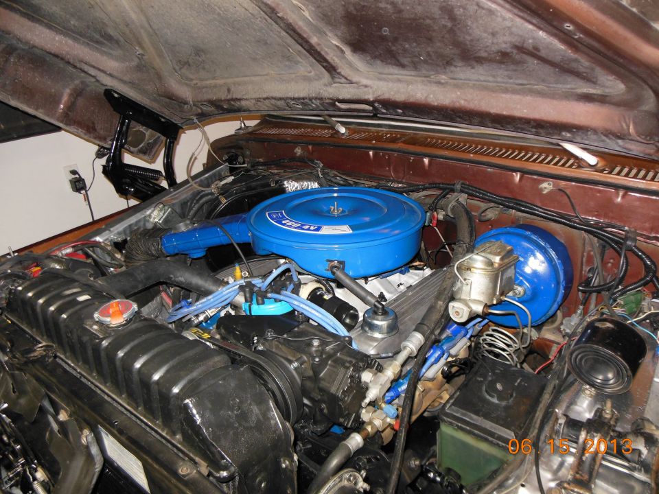 Engine bay with blue air cleaner and brake booster