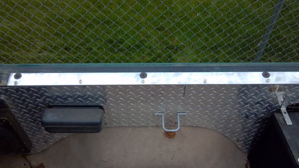 Passenger side tonneau rail.  2"x1/4" aluminum flat bar.  4 holes marked and drilled for the existing hard top.  Screw-in snap studs every 8".  I put the rail screws 1/2" from the outside edge.  You could center the rail, or move them to the inside edge if you prefer.  My constraint was the width of the fabric I had to work with.  I wanted to save enough of the 108" long roll to make a bikini cover, so I hugged the inside.