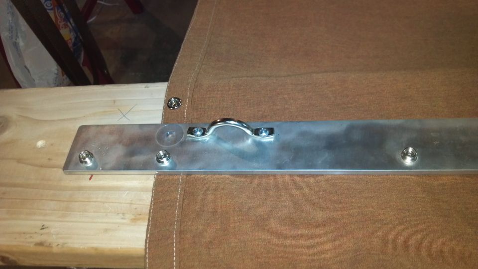 Brown tonneau cover with metal bracket and D-ring hardware