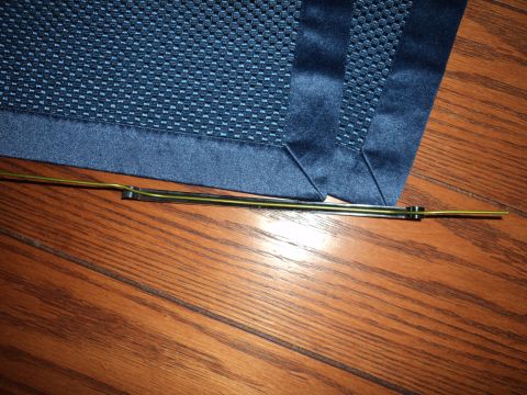 2004 Mercury Grand Marquis - A windshield wiper blade is shown resting on a wooden surface next to a blue textured fabric.