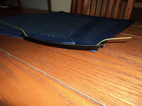 2004 Mercury Grand Marquis - Car floor mat with trim and a yellow wire is placed on a wooden table.