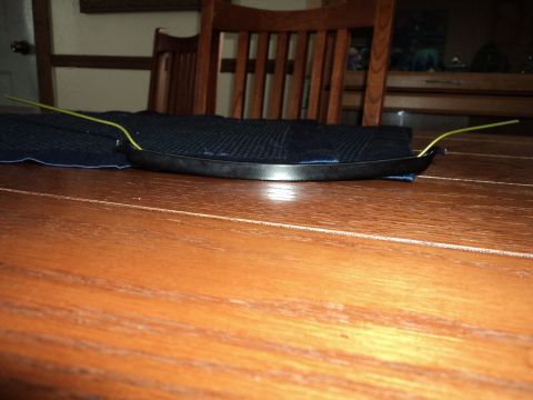 2004 Mercury Grand Marquis - A car grille is shown on a table, with yellow wires protruding from it.